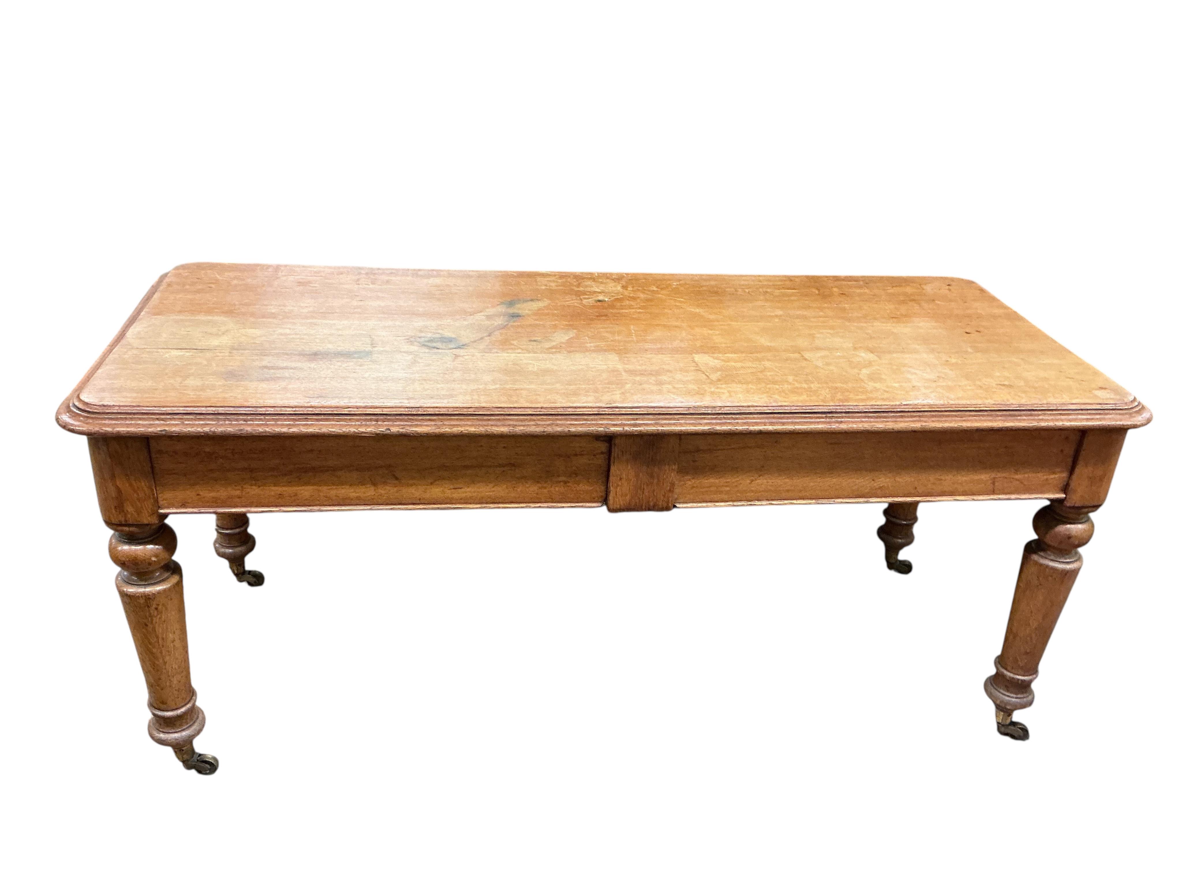 A Victorian light oak side table, fitted two drawers, on turned legs, width 180cm, depth 74cm, height 80cm